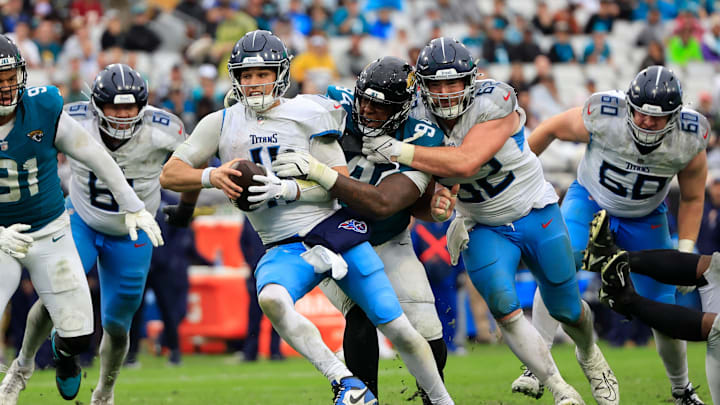 Jacksonville Jaguars defensive tackle Maason Smith (94) sacks Tennessee Titans quarterback Mason Rudolph (11) as Titans center Corey Levin (62) can’t help stop during the fourth quarter Sunday, Dec. 29, 2024 at EverBank Stadium in Jacksonville, Fla. The Jaguars held off the Titans 20-13. [Corey Perrine/Florida Times-Union]