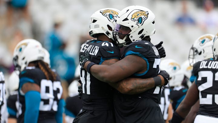 Jacksonville Jaguars offensive tackle Anton Harrison (77) hugs defensive end Josh Hines-Allen (41) before an NFL football matchup Sunday, Nov. 10, 2024 at Everbank Stadium in Jacksonville, Fla. [Corey Perrine/Florida Times-Union]