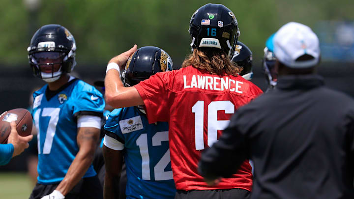 Jacksonville Jaguars quarterback Trevor Lawrence (16) taps wide receiver Travis Hunter (12) on the helmet as wide receiver Cam Camper (17) looks on during the first organized team activity at Miller Electric Center Monday, May 19, 2025 in Jacksonville, Fla.