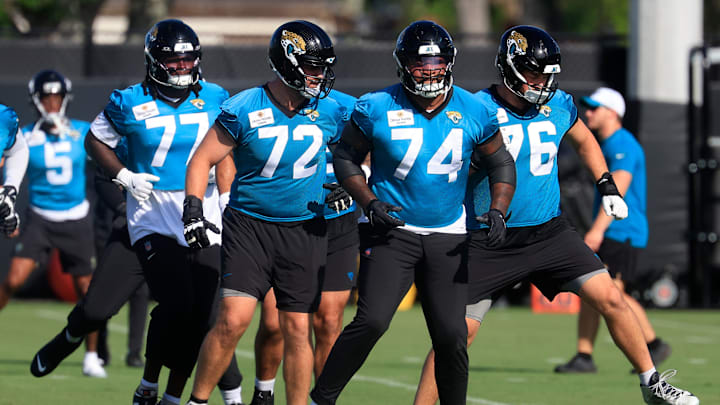 Jacksonville Jaguars offensive tackle Anton Harrison (77), offensive tackle Walker Little (72), offensive tackle Fred Johnson (74), and guard Ezra Cleveland (76) warm up during the second mandatory minicamp at Miller Electric Center Wednesday, June 11, 2025 in Jacksonville, Fla.