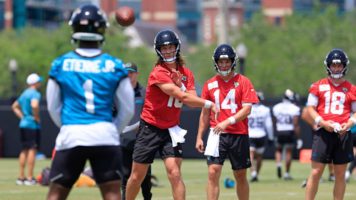 Jacksonville Jaguars quarterback Trevor Lawrence (16) throws the ball to running back Travis Etienne Jr. (1) during the first organized team activity at Miller Electric Center Monday, May 19, 2025 in Jacksonville, Fla.