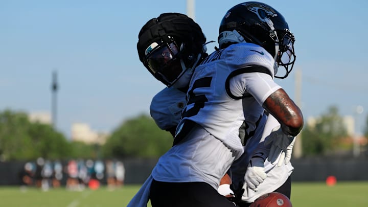 Jacksonville Jaguars defensive back Doneiko Slaughter (35) has the ball knocked away by defensive back Jabbar Muhammad (37) during an NFL training camp session at the Miller Electric Center, Tuesday, July 29, 2025, in Jacksonville, Fla. [Corey Perrine/Florida Times-Union]
