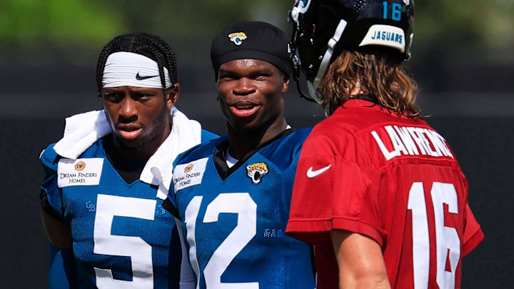 Jacksonville Jaguars wide receiver Travis Hunter (12) talks with quarterback Trevor Lawrence (16) as wide receiver Dyami Brown (5) looks on after an NFL training camp session at the Miller Electric Center, Sunday, Aug. 3, 2025, in Jacksonville, Fla. [Corey Perrine/Florida Times-Union]