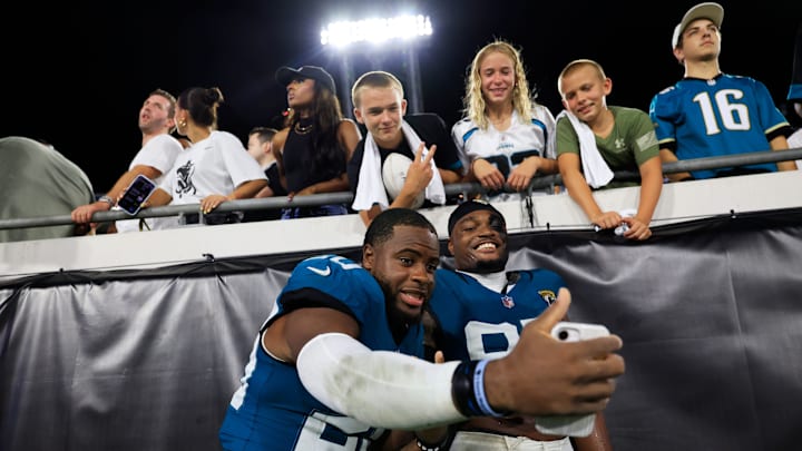 Jacksonville Jaguars safety Daniel Thomas (20), left, and defensive end BJ Green II (95) take a selfie for fans after the game of an NFL preseason matchup at EverBank Stadium, Saturday, Aug. 9, 2025 in Jacksonville, Fla. The Steelers defeated the Jaguars 31-25. [Corey Perrine/Florida Times-Union]