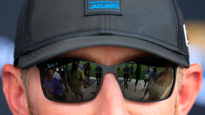 Members of the media are reflected in the glasses of Jacksonville Jaguars head coach Liam Coen during an interview after an NFL training camp session at the Miller Electric Center, Friday Aug. 15, 2025 in Jacksonville, Fla. [Corey Perrine/Florida Times-Union]