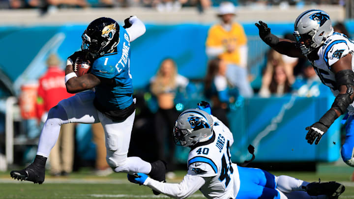 Jacksonville Jaguars running back Travis Etienne Jr. (1) breaks free from Carolina Panthers linebacker Deion Jones (40) during the second quarter of a regular season NFL football matchup Sunday, Dec. 31, 2023 at EverBank Stadium in Jacksonville, Fla. The Jacksonville Jaguars blanked the Carolina Panthers 26-0. [Corey Perrine/Florida Times-Union]