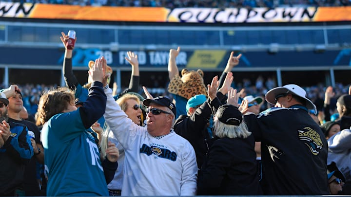 Jacksonville Jaguars fans high five each other after a touchdown score during the fourth quarter of a regular season NFL football matchup Sunday, Dec. 31, 2023 at EverBank Stadium in Jacksonville, Fla. The Jacksonville Jaguars blanked the Carolina Panthers 26-0. [Corey Perrine/Florida Times-Union]