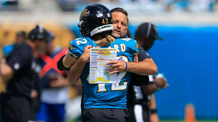 Jacksonville Jaguars defensive coordinator Anthony Campanile hugs safety Andrew Wingard (42) before an NFL football matchup at EverBank Stadium, Sunday, Sept. 21, 2025, in Jacksonville, Fla. The Jaguars defeated the Texans 17-10.