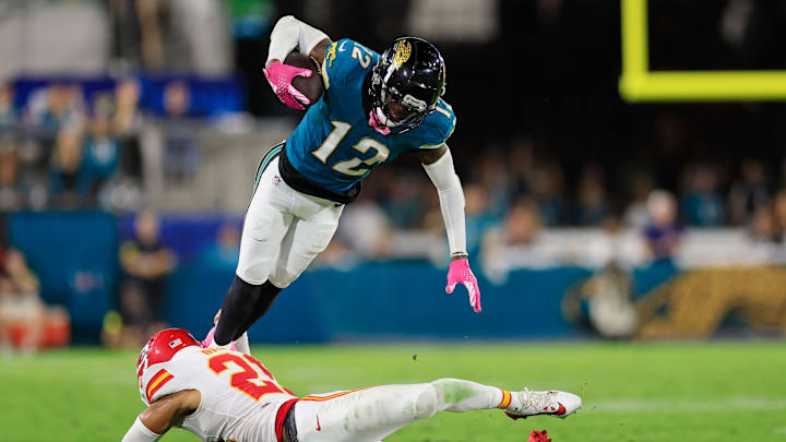 Jacksonville Jaguars wide receiver Travis Hunter (12) is tackled by Kansas City Chiefs safety Jaden Hicks (21) during the third quarter of an NFL football matchup at EverBank Stadium, Monday, Oct. 6, 2025, in Jacksonville, Fla. The Jacksonville Jaguars edged the Kansas City Chiefs 31-28. [Corey Perrine/Florida Times-Union]