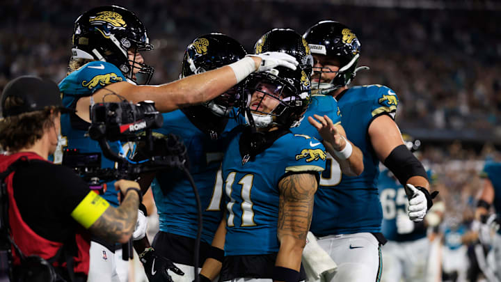 Jacksonville Jaguars tight end Hunter Long (84), left, pats the head of wide receiver Parker Washington (11) who scored a touchdown during the second quarter of an NFL football matchup at EverBank Stadium, Monday, Oct. 6, 2025, in Jacksonville, Fla. The Jacksonville Jaguars edged the Kansas City Chiefs 31-28. [Corey Perrine/Florida Times-Union]
