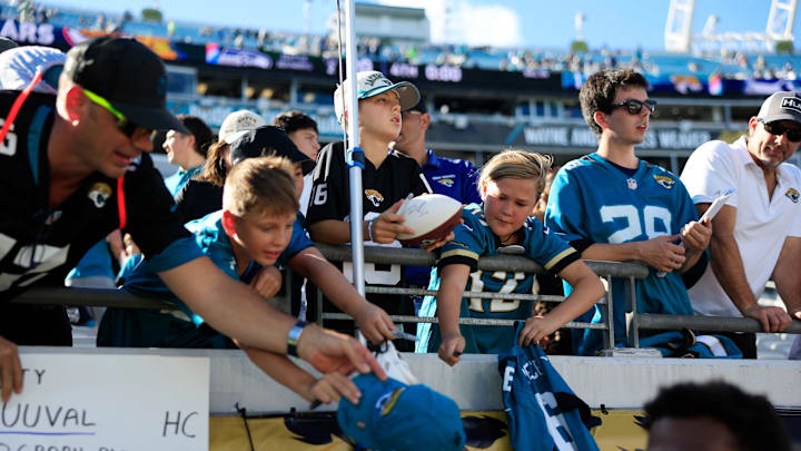 Jacksonville Jaguars fans clamour for autographs after the game of an NFL football matchup, Sunday, Oct. 12, 2025, at EverBank Stadium in Jacksonville, Fla. The Seahawks defeated the Jaguars 20-12.