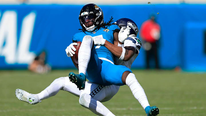 Jacksonville Jaguars wide receiver Brian Thomas Jr. (7) is tackled by Seattle Seahawks safety Nick Emmanwori (3) during the fourth quarter of an NFL football matchup, Sunday, Oct. 12, 2025, at EverBank Stadium in Jacksonville, Fla. The Seahawks defeated the Jaguars 20-12. [Corey Perrine/Florida Times-Union]