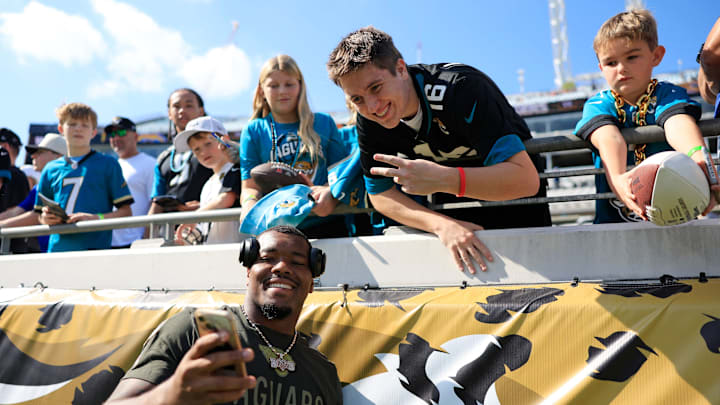 Jacksonville Jaguars defensive end Travon Walker (44) takes a selfie with a fan before an NFL football game at EverBank Stadium, Sunday, Nov. 16, 2025 in Jacksonville, Fla. [Corey Perrine/Florida Times-Union]