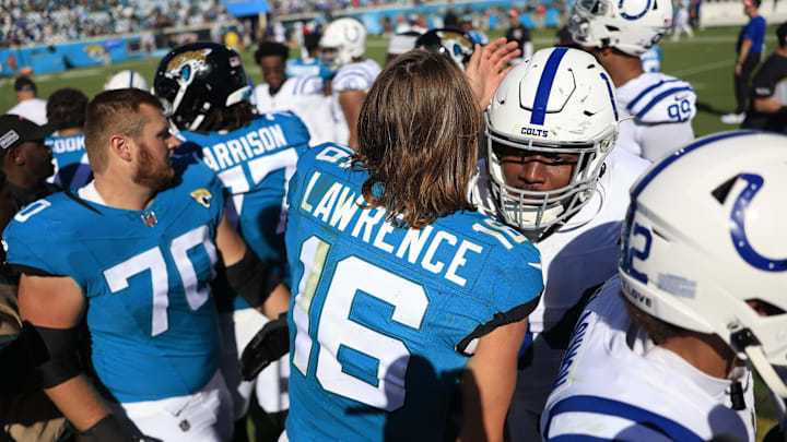 Jacksonville Jaguars quarterback Trevor Lawrence (16) hugs Indianapolis Colts defensive end Tyquan Lewis (94) after the game an NFL football matchup Sunday, Oct. 15, 2023 at EverBank Stadium in Jacksonville, Fla. The Jacksonville Jaguars defeated the Indianapolis Colts 37-20. [Corey Perrine/Florida Times-Union]