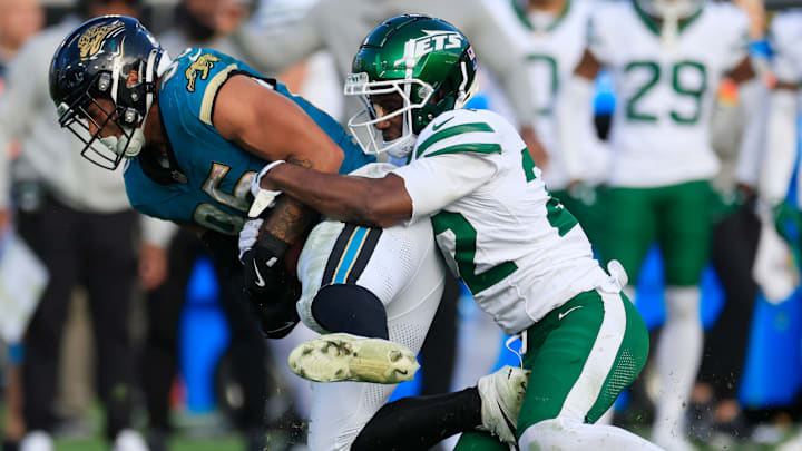 Jacksonville Jaguars tight end Brenton Strange (85) is tackled by New York Jets safety Tony Adams (22) during the fourth quarter Sunday, Dec. 15, 2024 at EverBank Stadium in Jacksonville, Fla. The Jets held off the Jaguars 32-25. [Corey Perrine/Florida Times-Union]
