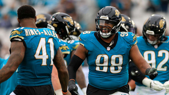 Jacksonville Jaguars defensive end Dawuane Smoot (98) is high-fived by defensive end Josh Hines-Allen (41) during the fourth quarter of an NFL football matchup at EverBank Stadium, Sunday, Jan. 4, 2026, in Jacksonville, Fla. The Jaguars defeated the Titans 41-7, capturing the AFC South title. [Corey Perrine/Florida Times-Union]