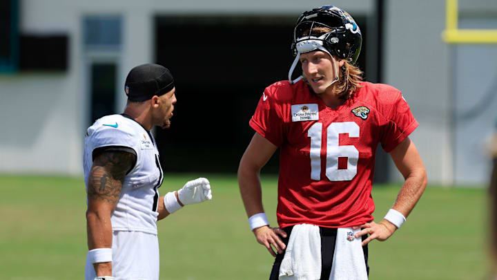 Jacksonville Jaguars wide receiver Parker Washington (11), left, and quarterback Trevor Lawrence (16) talk after an NFL training camp session at the Miller Electric Center, Thursday, Aug. 14, 2025 in Jacksonville, Fla.
