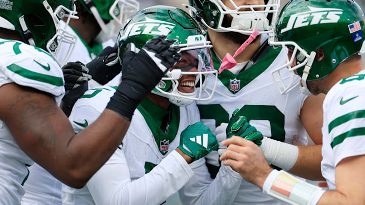New York Jets wide receiver Garrett Wilson (5) celebrates his touchdown wth quarterback Aaron Rodgers (8) during the first quarter Sunday, Dec. 15, 2024 at EverBank Stadium in Jacksonville, Fla.