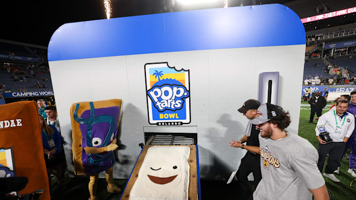 Dec 28, 2024; Orlando, FL, USA; Iowa State Cyclones head coach Matt Campbell and quarterback Rocco Becht (3) celebrate after beating Miami Hurricanes in the Pop Tarts bowl at Camping World Stadium. Mandatory Credit: Nathan Ray Seebeck-Imagn Images