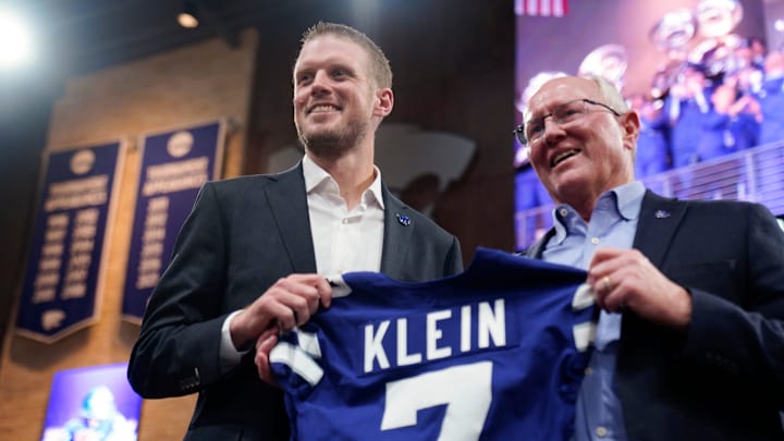 Kansas State new head football coach Collin Klein holds a jersey given by athletic director Gene Taylor during his introduction ceremony at Morgan Family Arena on Dec. 5, 2025. Kansas State new head football coach Collin Klein holds a jersey given by athletic director Gene Taylor during his introduction ceremony at Morgan Family Arena on Dec. 5, 2025.