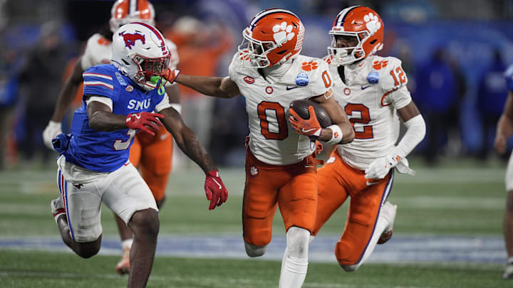 Dec 7, 2024; Charlotte, NC, USA; Clemson Tigers wide receiver Antonio Williams (0) runs against Southern Methodist Mustangs safety Ahmaad Moses (3) during the third quarter in the 2024 ACC Championship game at Bank of America Stadium. Mandatory Credit: Jim Dedmon-Imagn Images