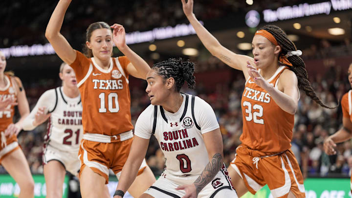 South Carolina Gamecocks guard Te-Hina Paopao moves on the court defended by Texas Longhorns guard Shay Holle and guard Ndjakalenga Mwenentanda