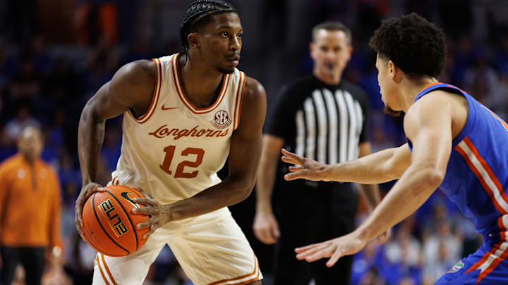 Jan 18, 2025; Gainesville, Florida, USA; Texas Longhorns guard Tramon Mark (12) looks to pass away from Florida Gators guard Walter Clayton Jr. (1) during the first half at Exactech Arena at the Stephen C. O'Connell Center. Mandatory Credit: Matt Pendleton-Imagn Images