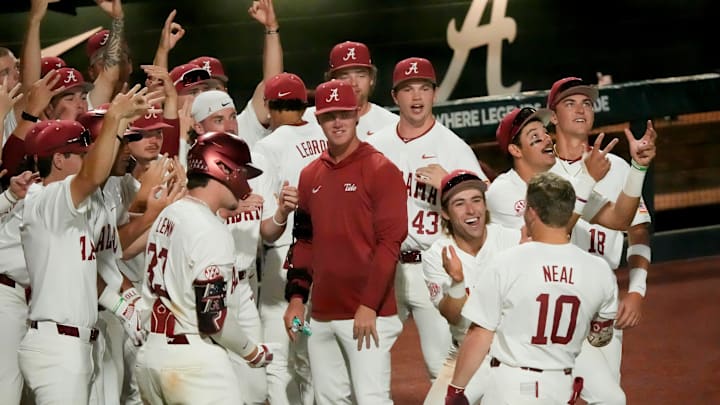 April 10, 2026; Tuscaloosa, AL, USA; Teammates congratulate Brady Neal after his solo homer at Sewell-Thomas Stadium in game one of the weekend series between Alabama and Arkansas.