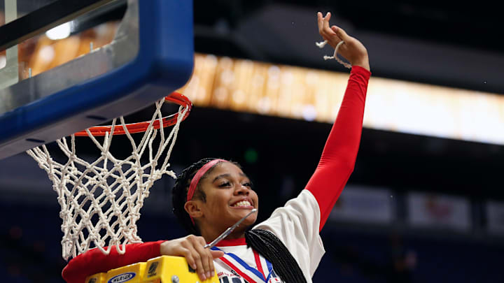 Sacred Heart's Zakiyah Johnson celebrates her piece of the net after they beat McCracken County in the Mingua Beef Jerky Sweet 16 Girls Basketball Championship.