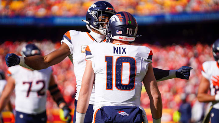 Nov 10, 2024; Kansas City, Missouri, USA; Denver Broncos wide receiver Courtland Sutton (14) celebrates with quarterback Bo Nix (10) after scoring against the Kansas City Chiefs during the first half at GEHA Field at Arrowhead Stadium. 