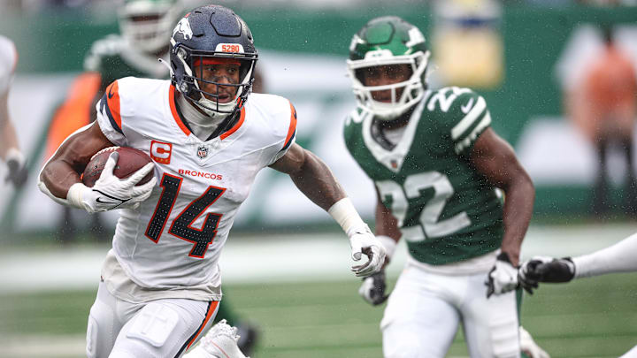 Sep 29, 2024; East Rutherford, New Jersey, USA; Denver Broncos wide receiver Courtland Sutton (14) gains yards after catch in front of New York Jets safety Tony Adams (22) during the second half at MetLife Stadium. Sep 29, 2024; East Rutherford, New Jersey, USA; Denver Broncos wide receiver Courtland Sutton (14) gains yards after catch in front of New York Jets safety Tony Adams (22) during the second half at MetLife Stadium.