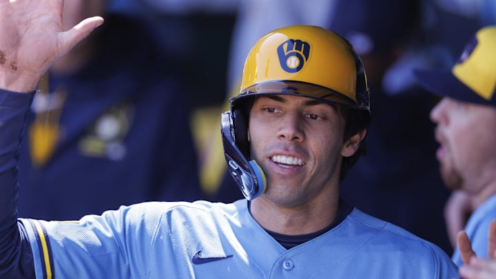 Apr 4, 2026; Kansas City, Missouri, USA; Milwaukee Brewers left fielder Christian Yelich (22) celebrates in the dugout after scoring during the first inning against the Kansas City Royals at Kauffman Stadium. Mandatory Credit: William Purnell-Imagn Images