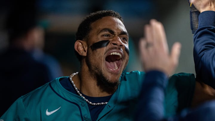 Seattle Mariners centerfielder Julio Rodriguez (44) celebrates in the dugout after scoring a run during the seventh inning against the Oakland Athletics at T-Mobile Park in 2024.