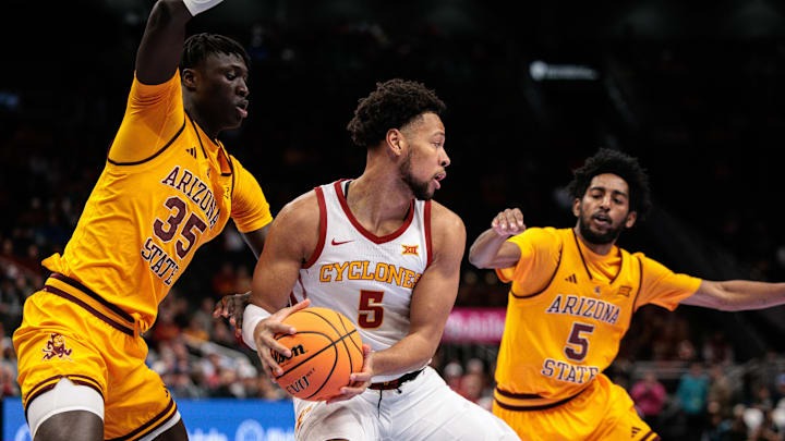 Mar 11, 2026; Kansas City, MO, USA; Iowa State Cyclones forward Joshua Jefferson (5) protects the ball from Arizona State Sun Devils center Massamba Diop (35) during the first half at T-Mobile Center.