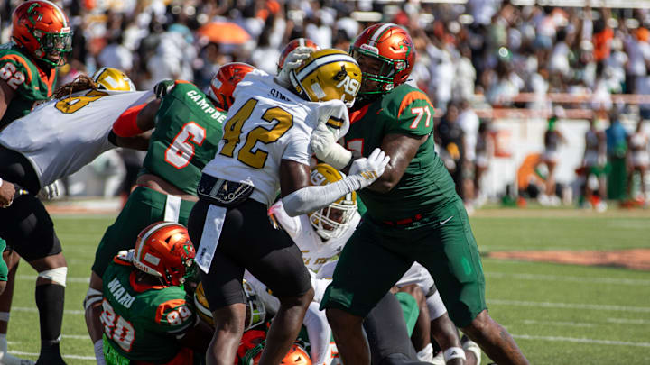 Alabama State Safety Ta'Shaun Sims (42) defends against Florida A&M Offensive Lineman Ashton Grable (71) as the Rattlers continue their offensive drive.