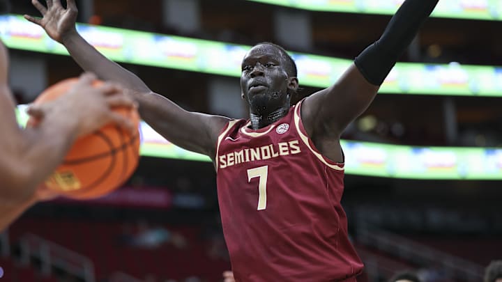 Nov 9, 2024; Houston, Texas, USA; Florida State Seminoles forward Jerry Deng (7) defends on a play during the first half against the Rice Owls at Toyota Center. Mandatory Credit: Troy Taormina-Imagn Images