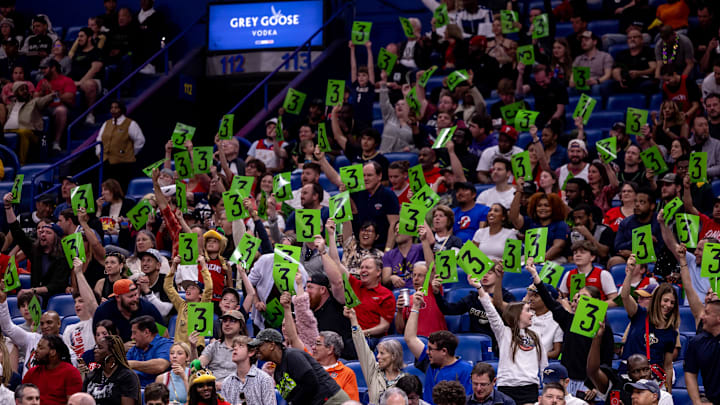 Apr 5, 2024; New Orleans, Louisiana, USA; New Orleans Pelicans fans hold up three point basket signs against the San Antonio Spurs during the first half at Smoothie King Center. Mandatory Credit: Stephen Lew-Imagn Images