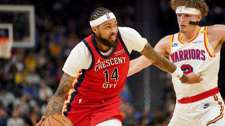 Oct 29, 2024; San Francisco, California, USA; New Orleans Pelicans forward Brandon Ingram (14) dribbles past Golden State Warriors guard Brandin Podziemski (2) in the third quarter at the Chase Center. Mandatory Credit: Cary Edmondson-Imagn Images