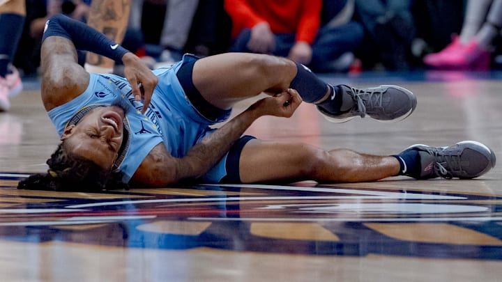 Dec 27, 2024; New Orleans, Louisiana, USA; Memphis Grizzlies guard Ja Morant (12) reacts after a screen by New Orleans Pelicans center Daniel Theis (10) during the third quarter at Smoothie King Center. Mandatory Credit: Matthew Hinton-Imagn Images