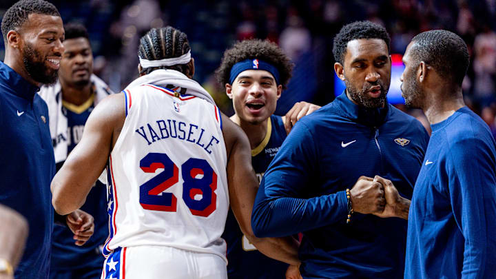Mar 24, 2025; New Orleans, Louisiana, USA;  New Orleans Pelicans guard Lester Quinones (22)  hugs Philadelphia 76ers forward Guerschon Yabusele (28) after the game at Smoothie King Center. Mandatory Credit: Stephen Lew-Imagn Images