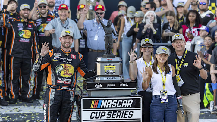 Oct 19, 2025; Talladega, Alabama, USA; NASCAR Cup Series driver Chase Briscoe (19) at left celebrates his win in victory lane at the YellaWood 500 at Talladega Superspeedway.