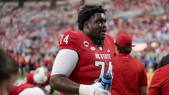 Sep 7, 2024; Charlotte, North Carolina, USA; North Carolina State Wolfpack offensive tackle Anthony Belton (74) during pregame activities against the Tennessee Volunteers at the Dukes Mayo Classic at Bank of America Stadium. Mandatory Credit: Jim Dedmon-Imagn Images