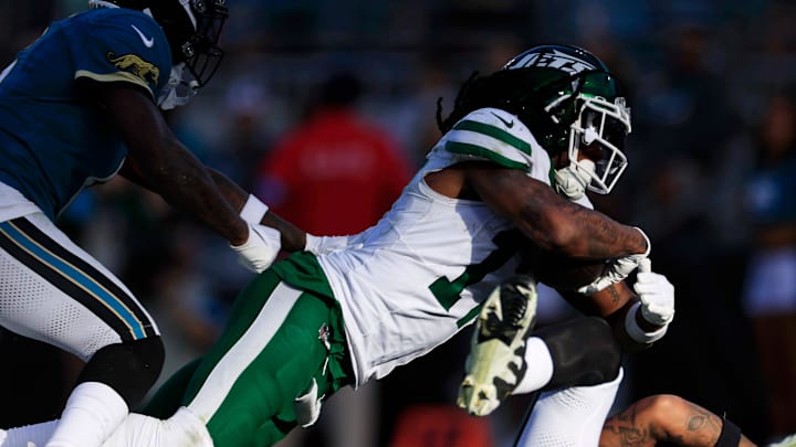 Jacksonville Jaguars safety Darnell Savage (6), from left, can’t stop New York Jets wide receiver Davante Adams (17) from scoring the game-winning touchdown as Jagaurs safety Antonio Johnson (26) loses his footing during the fourth quarter Sunday, Dec. 15, 2024 at EverBank Stadium in Jacksonville, Fla. The Jets held off the Jaguars 32-25. [Corey Perrine/Florida Times-Union]