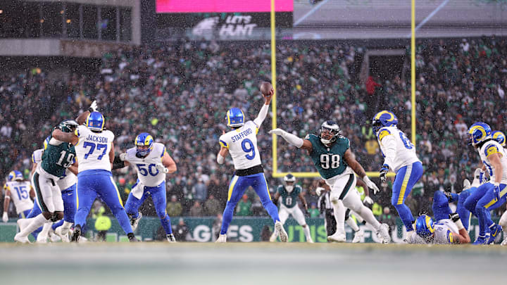 Jan 19, 2025; Philadelphia, Pennsylvania, USA; Los Angeles Rams quarterback Matthew Stafford (9) throws the ball as Philadelphia Eagles defensive tackle Jalen Carter (98) defends in the second quarter in a 2025 NFC divisional round game at Lincoln Financial Field. Mandatory Credit: Bill Streicher-Imagn Images