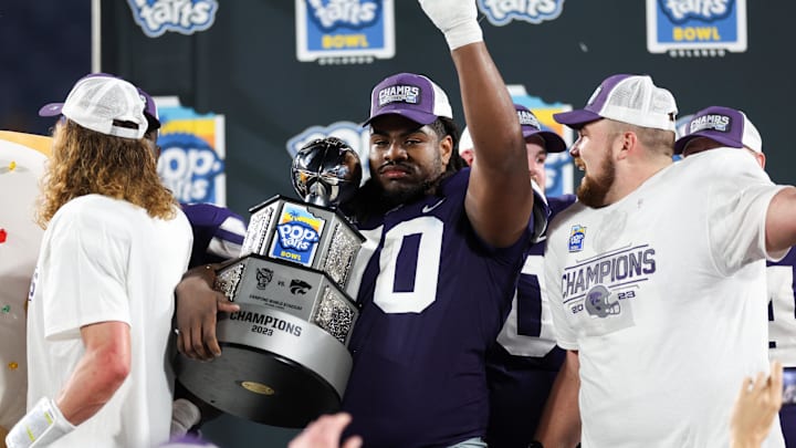 Dec 28, 2023; Orlando, FL, USA; Kansas State Wildcats offensive lineman KT Leveston (70) celebrates after beating the North Carolina State Wolfpack in the Pop-Tarts bowl at Camping World Stadium. Mandatory Credit: Nathan Ray Seebeck-Imagn Images Dec 28, 2023; Orlando, FL, USA; Kansas State Wildcats offensive lineman KT Leveston (70) celebrates after beating the North Carolina State Wolfpack in the Pop-Tarts bowl at Camping World Stadium. Mandatory Credit: Nathan Ray Seebeck-Imagn Images
