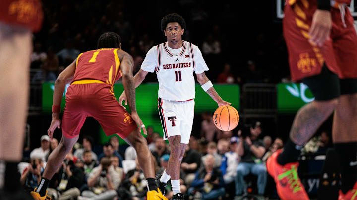 Mar 12, 2026; Kansas City, MO, USA; Texas Tech Red Raiders guard Jaylen Petty (11) brings the ball up court around Iowa State Cyclones guard Jamarion Batemon (1) during the first half at T-Mobile Center. Mandatory Credit: William Purnell-Imagn Images