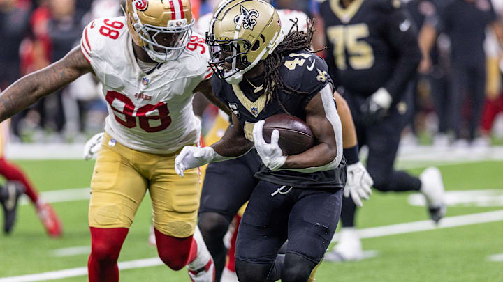 Sep 14, 2025; New Orleans, Louisiana, USA;  San Francisco 49ers defensive end Mykel Williams (98) tackles New Orleans Saints running back Alvin Kamara (41) during the second half at Caesars Superdome. Mandatory Credit: Stephen Lew-Imagn Images