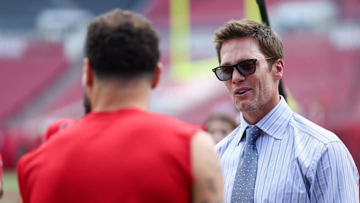 Fox NFL broadcaster and former NFL quarterback Tom Brady speaks to Tampa Bay Buccaneers wide receiver Mike Evans (13) before a game against the Philadelphia Eagles at Raymond James Stadium. 