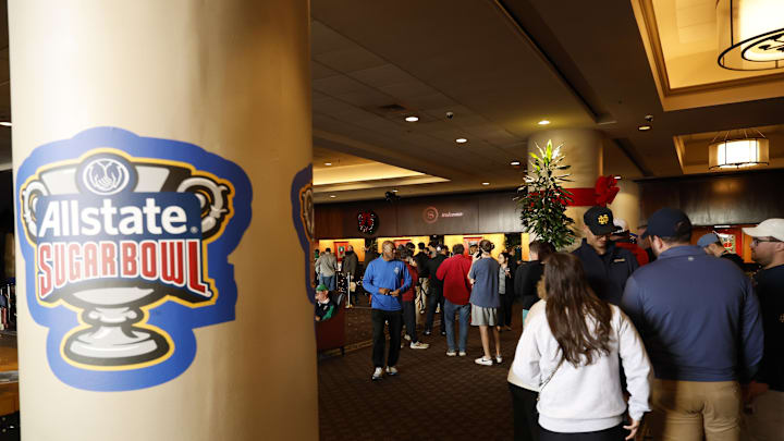 Fans at a hotel front desk after the postponement of the Sugar Bowl on Jan. 1, 2025.