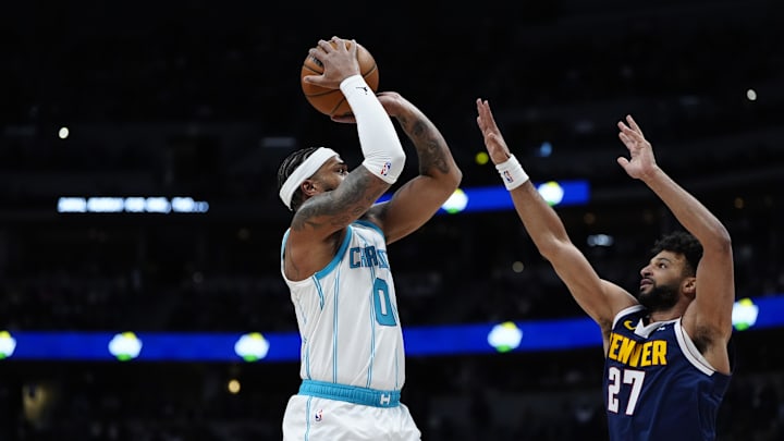 Feb 20, 2025; Denver, Colorado, USA; Denver Nuggets guard Jamal Murray (27) defends on Charlotte Hornets forward Miles Bridges (0) in the first quarter at Ball Arena. Mandatory Credit: Ron Chenoy-Imagn Images